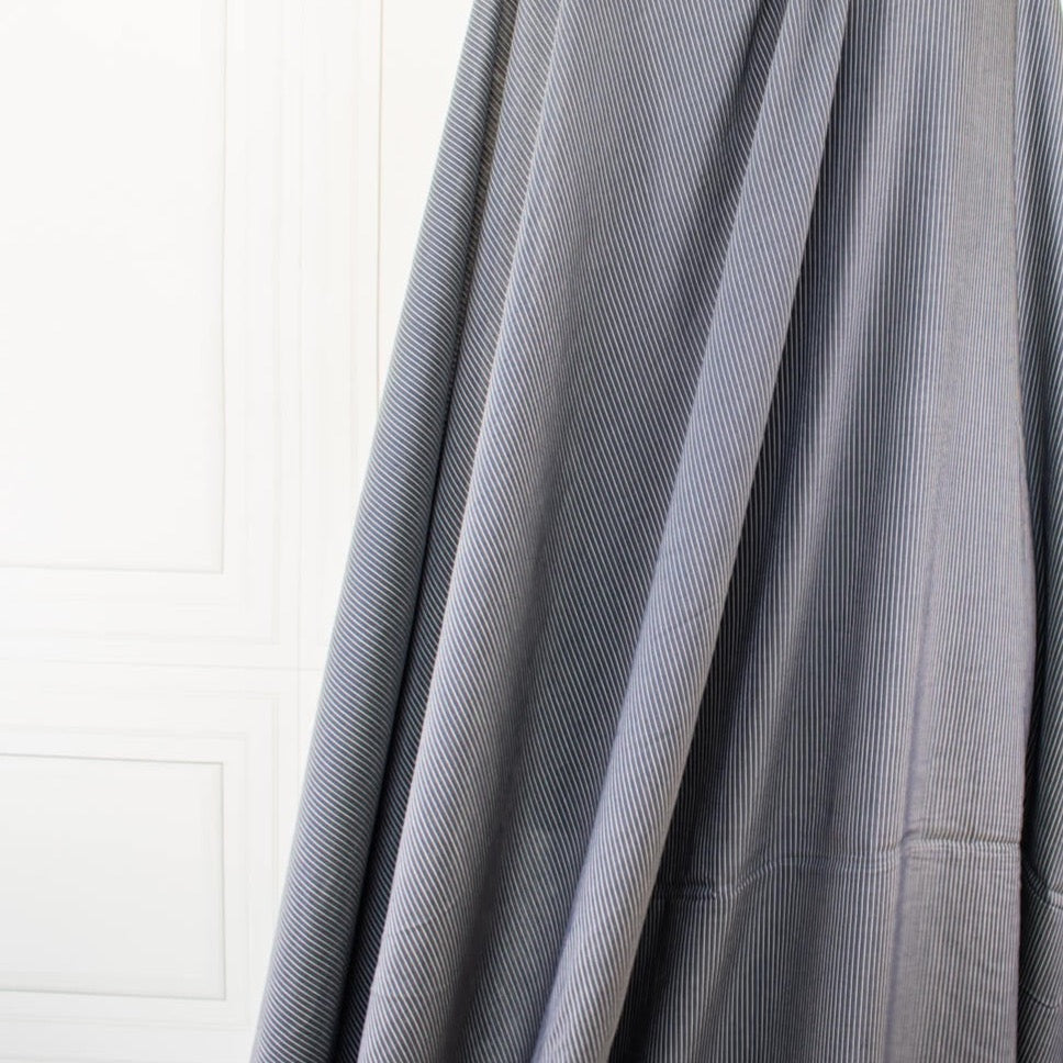 NYC Designer Deadstock Cotton Voile fabric by the yard. Amazingly soft and silky, this Navy/White horizontal stripe voile is lightweight with a thin hand, a must for warmer temperatures. Image of fabric drape.