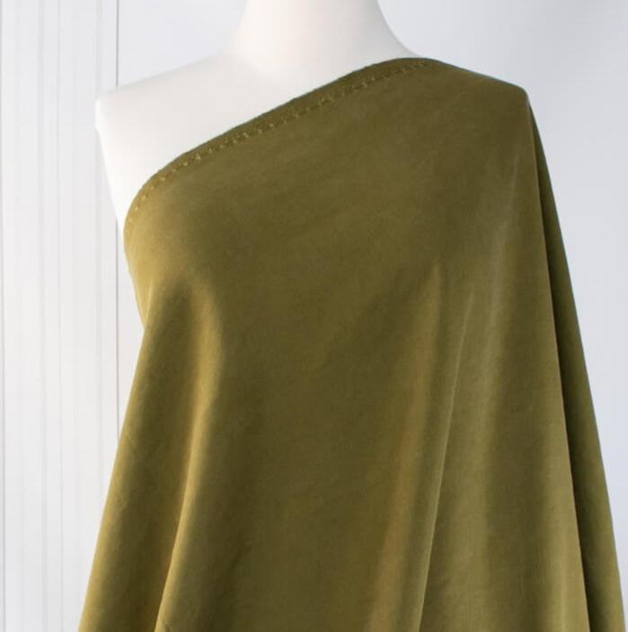 NYC Designer deadstock fabric by the yard. This linen and cotton blend shirting has such a lovely soft hand you'll absolutely love it. The fabric has a  supple drape, and leans towards a mid-weight. Close up image of fabric draped on dressform.