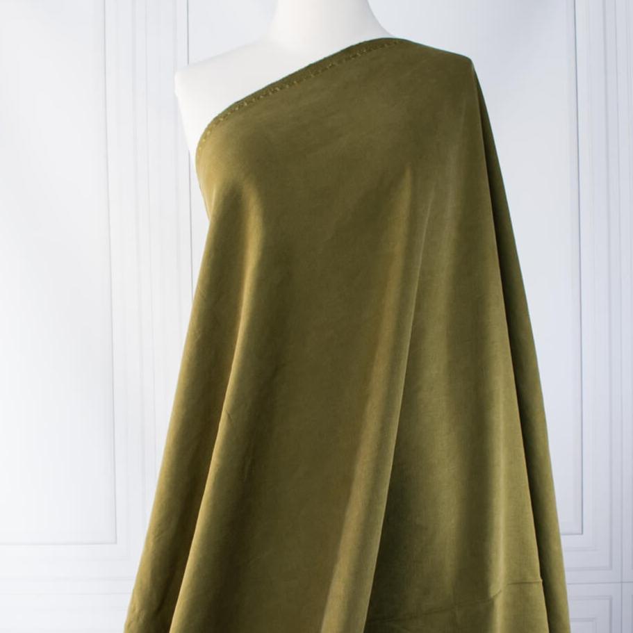NYC Designer deadstock fabric by the yard. This linen and cotton blend shirting has such a lovely soft hand you'll absolutely love it. The fabric has a  supple drape, and leans towards a mid-weight. Image of fabric draped on dressform.