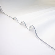 NYC Designer Linen blend designer deadstock fabric by the yard is the perfect fabric if you just love linen.  A plain weave off-white fabric with a soft, slightly crisp hand.  Close up selvedge image.
