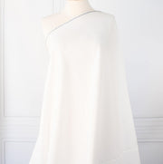 NYC Designer Linen blend designer deadstock fabric by the yard is the perfect fabric if you just love linen.  A plain weave off-white fabric with a soft, slightly crisp hand.  Image of fabric draped on dressform.
