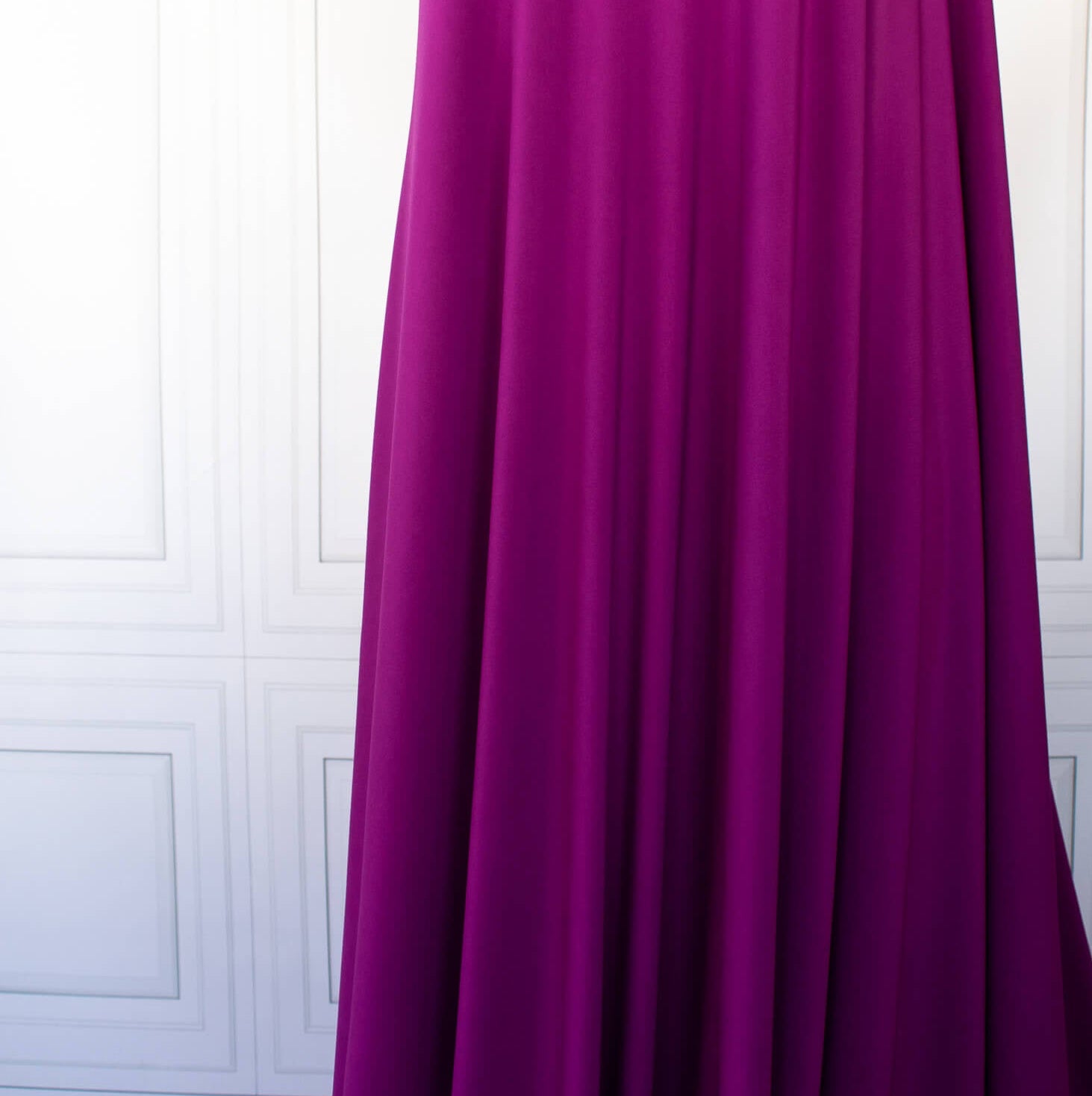 Designer ITY Solid Jersey Knit designer deadstock fabric by the yard. Perfect for travelwear, this ITY is universally flattering in a gorgeous light Orchid purple color. Image of fabric drape.