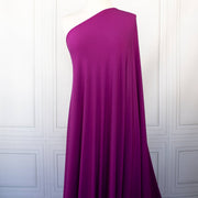Designer ITY Solid Jersey Knit designer deadstock fabric by the yard. Perfect for travelwear, this ITY is universally flattering in a gorgeous light Orchid purple color. Image of fabric drape on dressform.