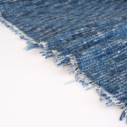 A beautifully soft NYC Designer Boucle suiting fabric by the yard that can be paired with sophisticated solids or your favorite denim. Varying shades of blue and alabaster yarns make this boucle extra special. Enjoy creating your next make with style and comfort. Image of fabric selvedge.