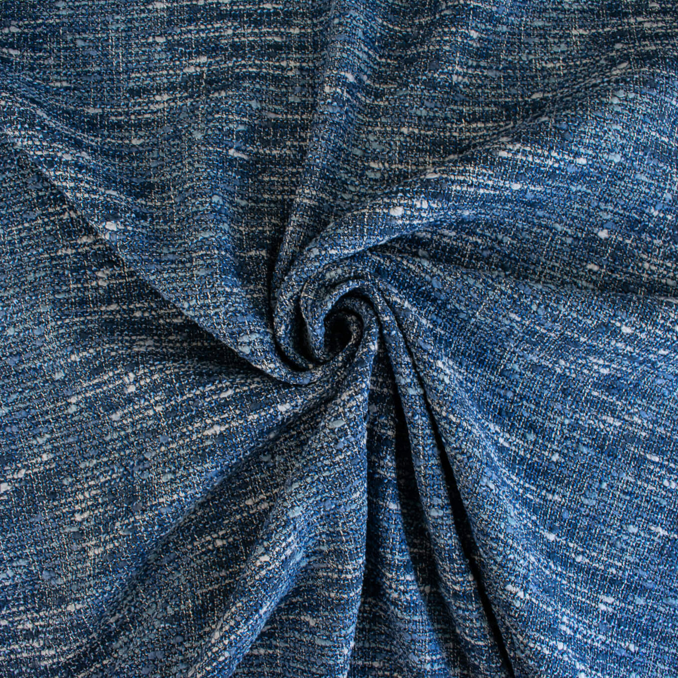 A beautifully soft NYC Designer Boucle suiting fabric by the yard that can be paired with sophisticated solids or your favorite denim. Varying shades of blue and alabaster yarns make this boucle extra special. Enjoy creating your next make with style and comfort. Image of fabric fullness.