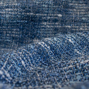 A beautifully soft NYC Designer Boucle suiting fabric by the yard that can be paired with sophisticated solids or your favorite denim. Varying shades of blue and alabaster yarns make this boucle extra special. Enjoy creating your next make with style and comfort. Close up of fabric weave.