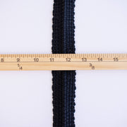 Vintage Foldover Black Braid Cotton Trim is back! This 1 and one-half inch trim can be folded to a sleek five-eighths of an inch creating a perfect clean finish for your sewing project. It also looks gorgeous as a base trim when layering trims for a designer look. Image of flattened trim and ruler to show width