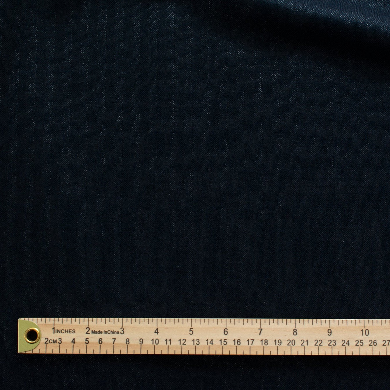 Image demonstrating scale of stripe pattern.  A gorgeous wool blend suiting from a Beverly Hills couture house is sure to add glamour to your outfit!  A soft textured hand with a herringbone stripe pattern that shimmers with silvery metallic threads. A perfect choice for a jacket, skirt, wide leg pant, or perhaps a coat dress.