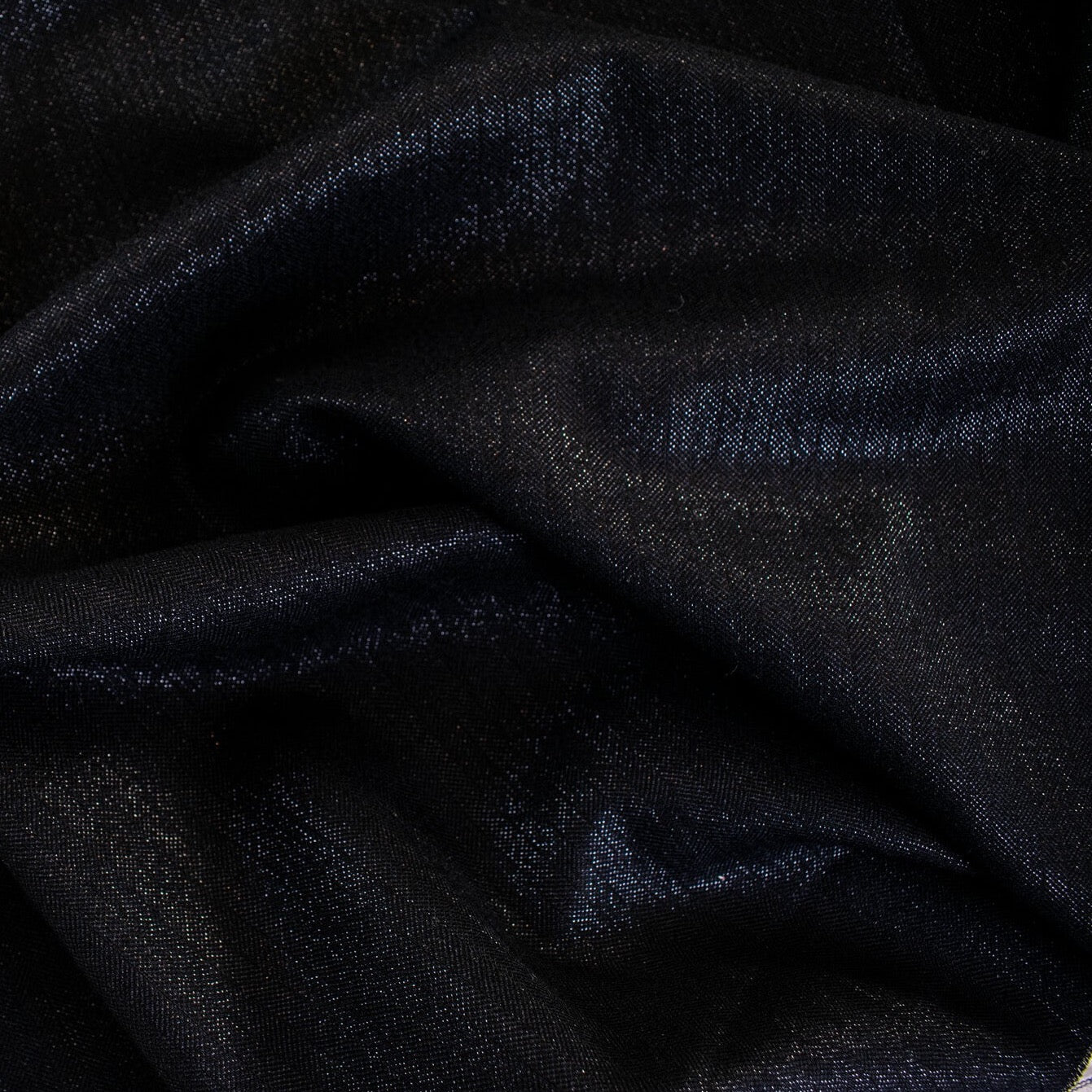 Image of fabric sheen. A gorgeous wool blend suiting from a Beverly Hills couture house is sure to add glamour to your outfit!  A soft textured hand with a herringbone stripe pattern that shimmers with silvery metallic threads. A perfect choice for a jacket, skirt, wide leg pant, or perhaps a coat dress.