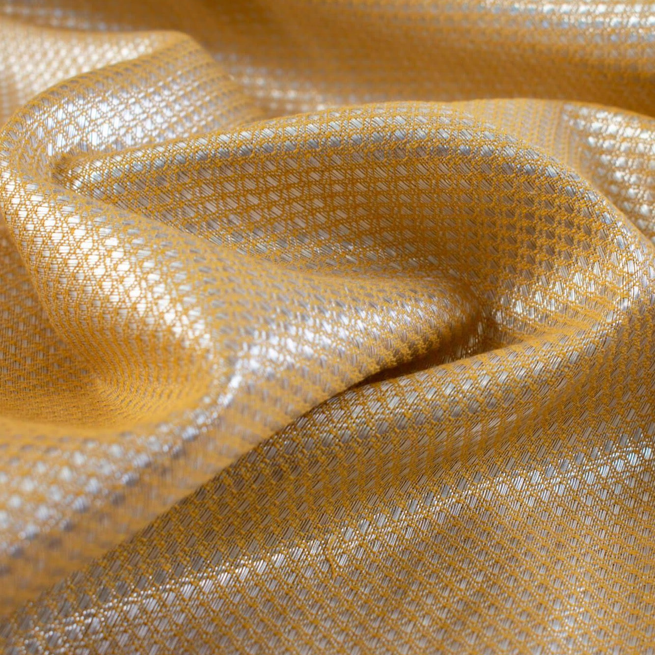 Enjoy a bit of Beverly Hills with this vintage designer deadstock. A gold jacquard with a timeless silver metallic geometric design at 36 inches wide and a selvedge that is just gorgeous. Photo of geometric pattern.