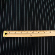Gorgeous Couture Designer 4-Ply Silk Black with a white vertical double pinstripe, this premium medium weight silk has a soft sheen and gentle drape. A fine smooth hand feels buttery on the skin, perfect for a wide leg pant, vest, jacket or dress! Image of fabric pattern with ruler to show scale.