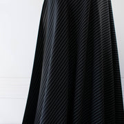 Gorgeous Couture Designer 4-Ply Silk Black with a white vertical double pinstripe, this premium medium weight silk has a soft sheen and gentle drape. A fine smooth hand feels buttery on the skin, perfect for a wide leg pant, vest, jacket or dress! Image of fabric drape.