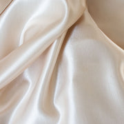 Designer dead stock fabric in a silky champagne polyester charmeuse. Canadian designer.