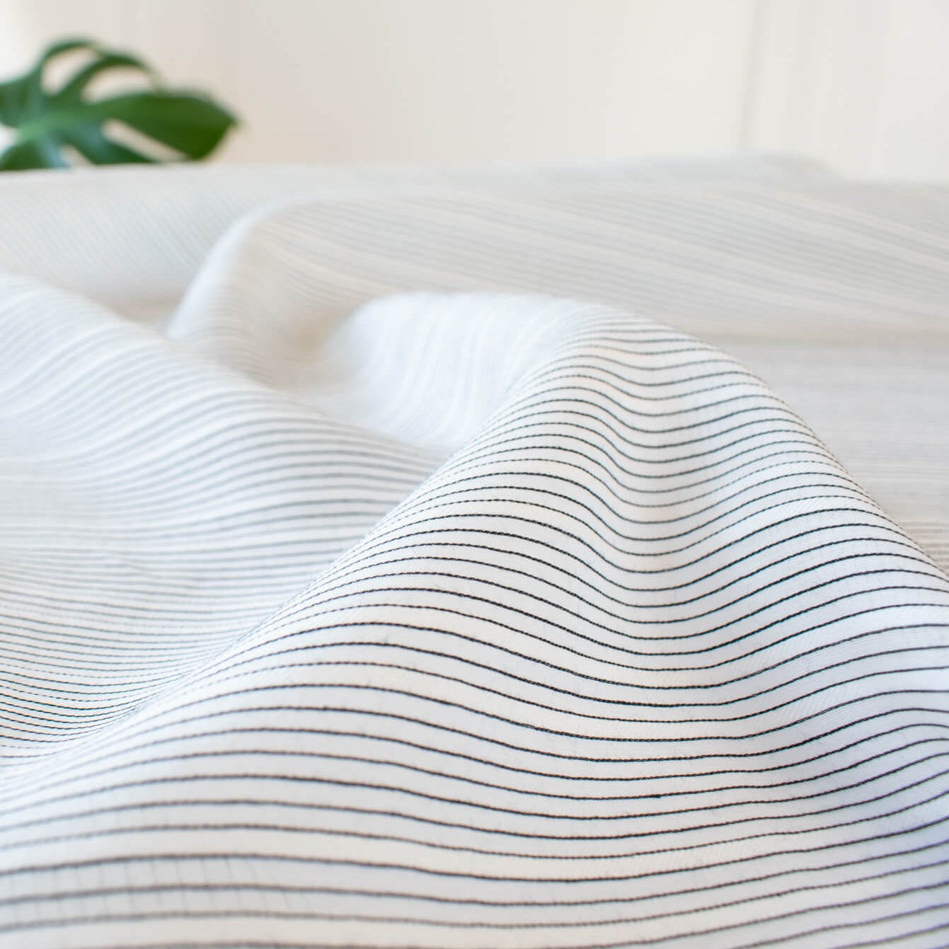 Light and airy Italian voile is soft and ohh so summery! Can you just picture yourself in a loose fitted unbuttoned shirtdress as a gorgeous layering piece over a cami and ankle length jeans.  This will definitely take your summer holiday up a notch!  Perfect for summer dresses, skirts and tops. The thin horizontal black stripes and bright white woven opaque stripes are set against a sheer white voile. For skirts and dresses we recommend an A-Line cut (won't those stripes look great on the bias) and lining.