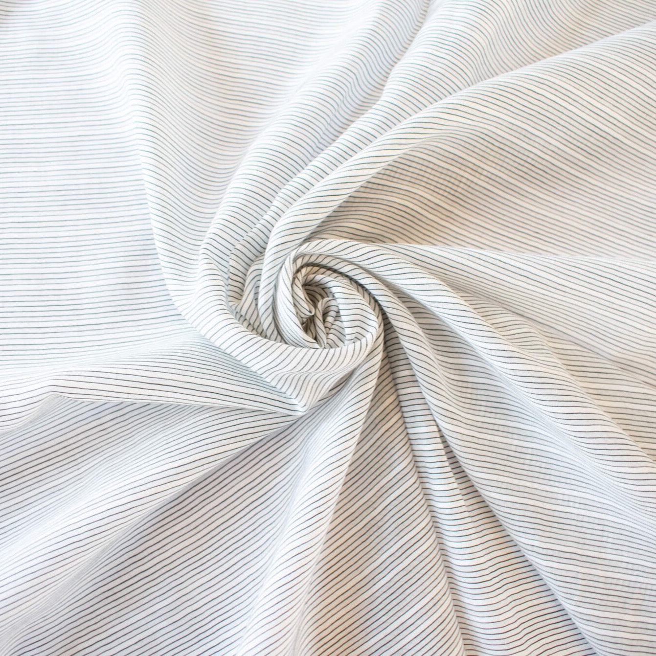ight and airy Italian voile is soft and ohh so summery! Can you just picture yourself in a loose fitted unbuttoned shirtdress as a gorgeous layering piece over a cami and ankle length jeans. This will definitely take your summer holiday up a notch! Perfect for summer dresses, skirts and tops. The thin horizontal black stripes and bright white woven opaque stripes are set against a sheer white voile Close up image. Image of fabric bo