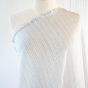 Light and airy Italian voile is soft and ohh so summery! Can you just picture yourself in a loose fitted unbuttoned shirtdress as a gorgeous layering piece over a cami and ankle length jeans.  This will definitely take your summer holiday up a notch!  Perfect for summer dresses, skirts and tops. The thin horizontal black stripes and bright white woven opaque stripes are set against a sheer white voile.  Fabric on dress form.