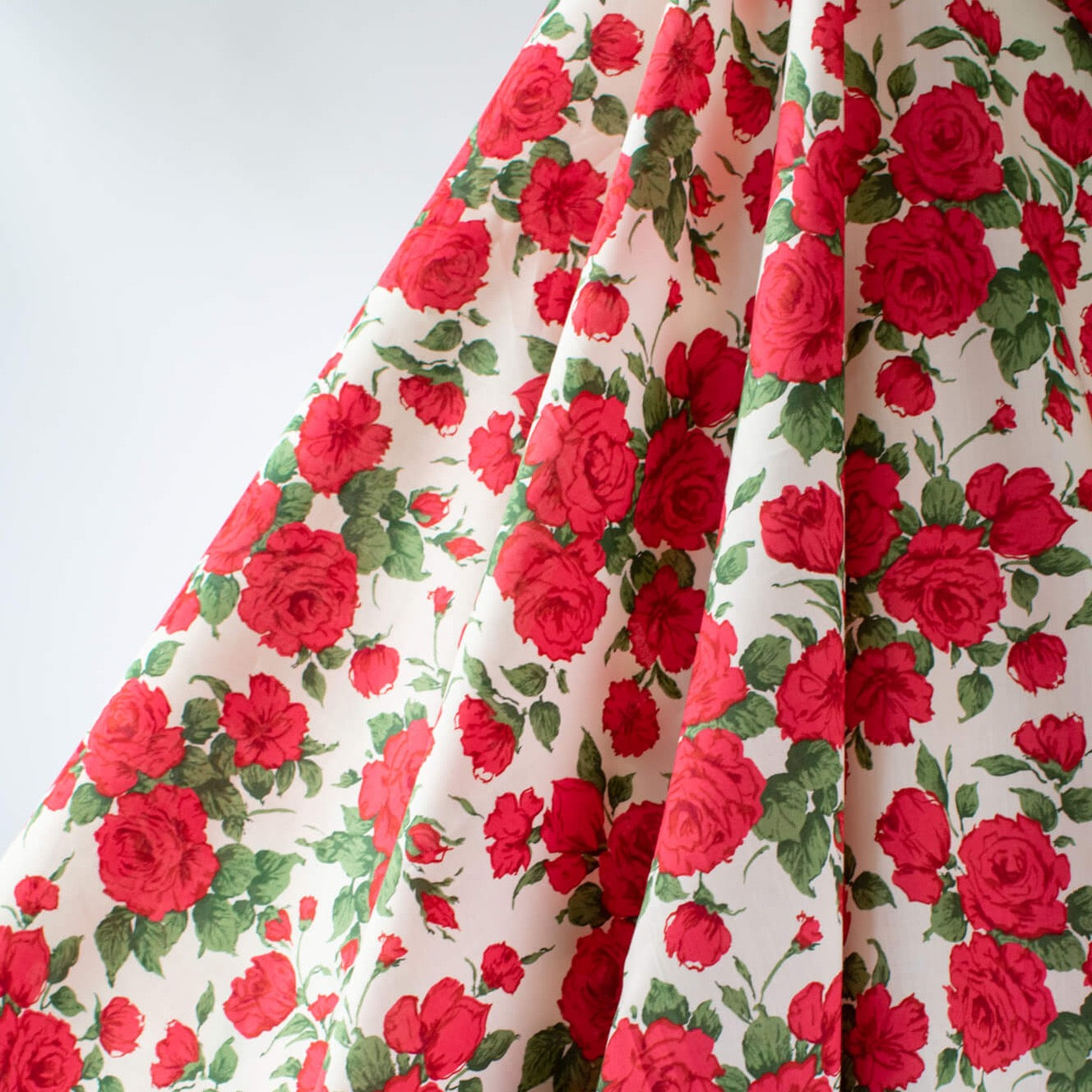 Create a stunning dress or a daring head to toe floral pant suit with this stunning Caroline Rose Tana Lawn fabric, a popular Liberty of London print. This particular print "...is an archival classic, originally painted in the 1990s to emulate the round beautiful forms of vintage 1950s florals." Photo of fabric drape.