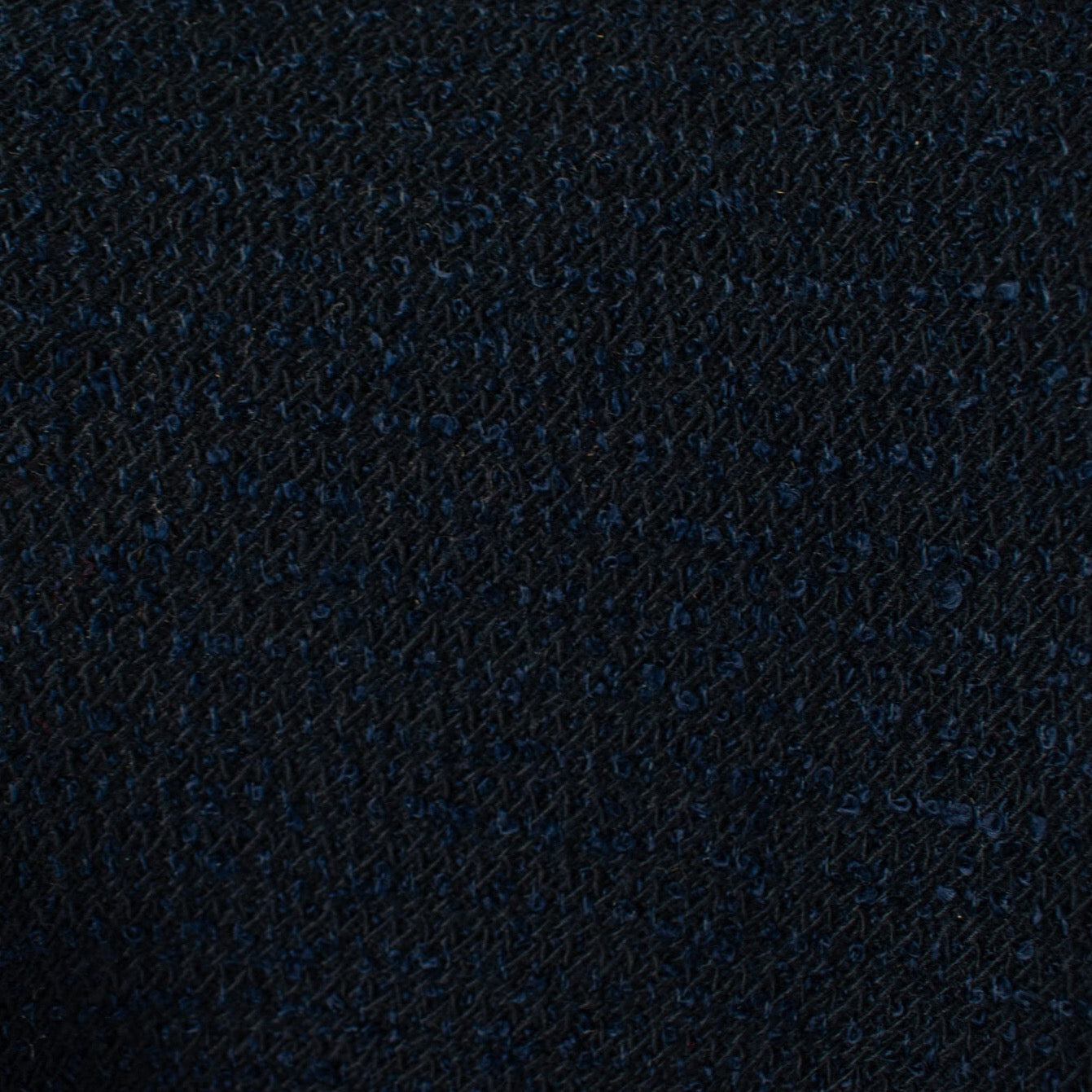 NY Designer boucle suiting with lovely strands of shimmering blue threads is a Classic French Jacket waiting to happen! This is a nice choice when you want something different than black but still want the drama and sophistication of a darker color. Close up image of boucle texture.