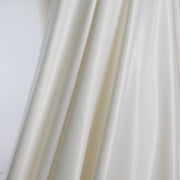 Steal the show in this NYC Designer pebble satin. A gorgeous light to medium weight off-white rayon satin that shimmers. Create a portrait worthy slip dress, bias skirt, or top! Image of fabric drape.