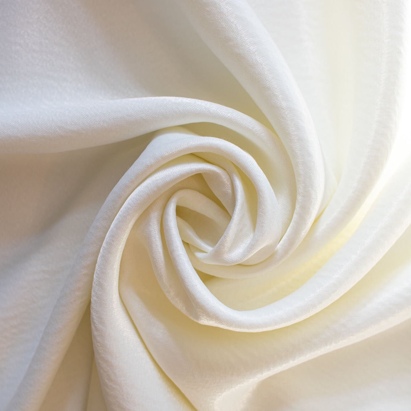 Steal the show in this NYC Designer pebble satin. A gorgeous light to medium weight off-white rayon satin that shimmers. Create a portrait worthy slip dress, bias skirt, or top! Image of fabric body.