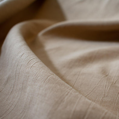 Washed linen blend has a soft, textured, slightly crisp hand, and some drape from the rayon. Make up a gorgeous top, dress or skirt that stands out!  Translucent with a washed look and pleasing slubbed texture, may need lining for dresses and skirts. Close up image.