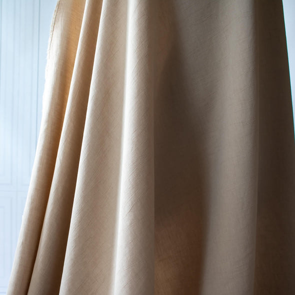 Washed linen blend has a soft, textured, slightly crisp hand, and some drape from the rayon. Make up a gorgeous top, dress or skirt that stands out!  Translucent with a washed look and pleasing slubbed texture, may need lining for dresses and skirts. Image of fabric drape.