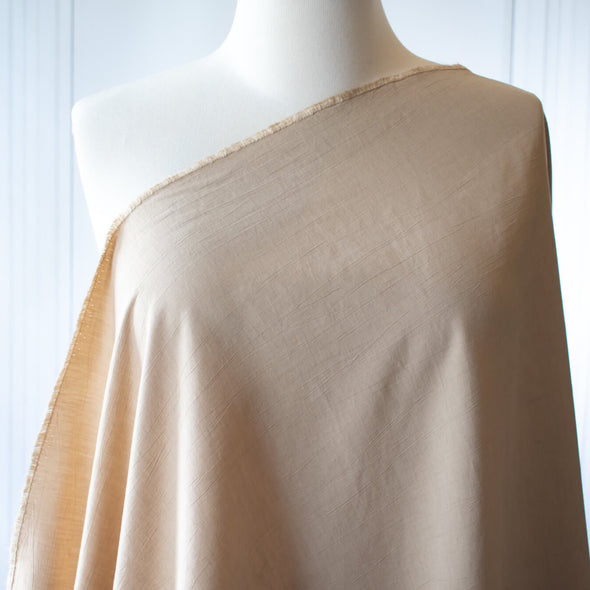 Washed linen blend has a soft, textured, slightly crisp hand, and some drape from the rayon. Make up a gorgeous top, dress or skirt that stands out!  Translucent with a washed look and pleasing slubbed texture, may need lining for dresses and skirts. Image of fabric draped on dress form.