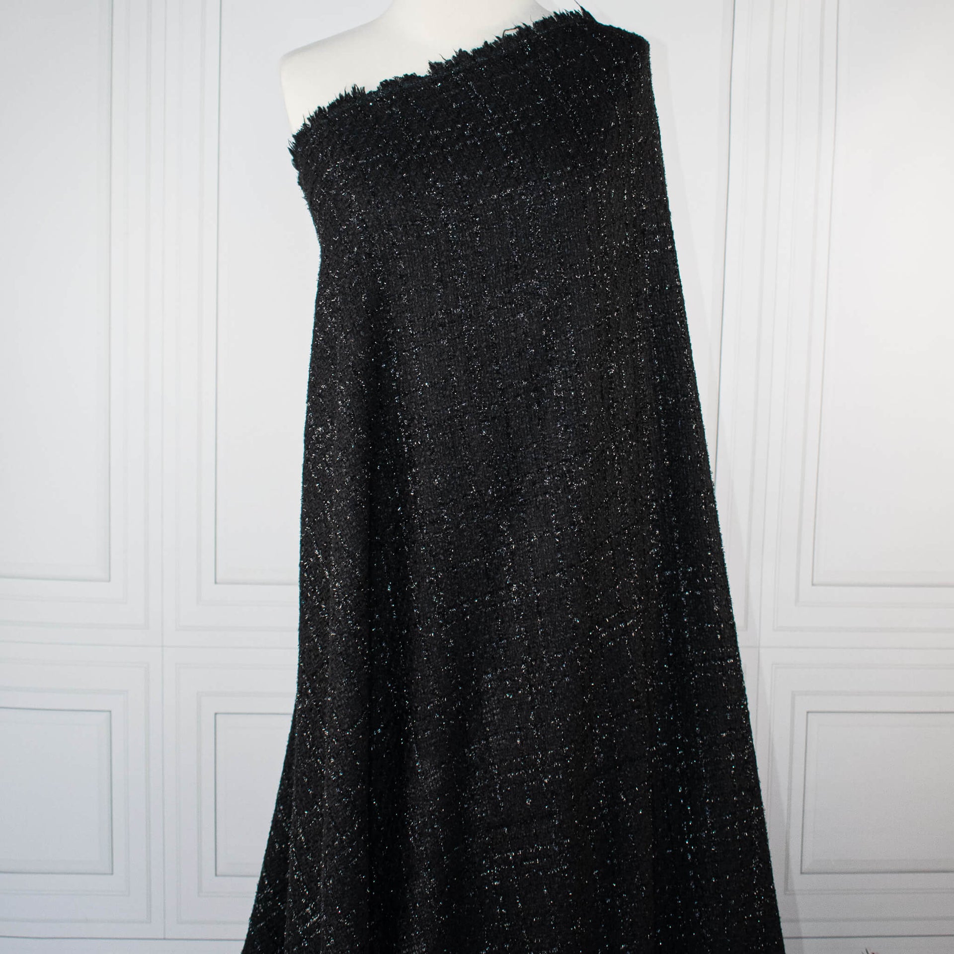 Metallic Black boucle fabric draped on dressform.