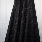 Designer Black Boucle fabric draped on dressform.