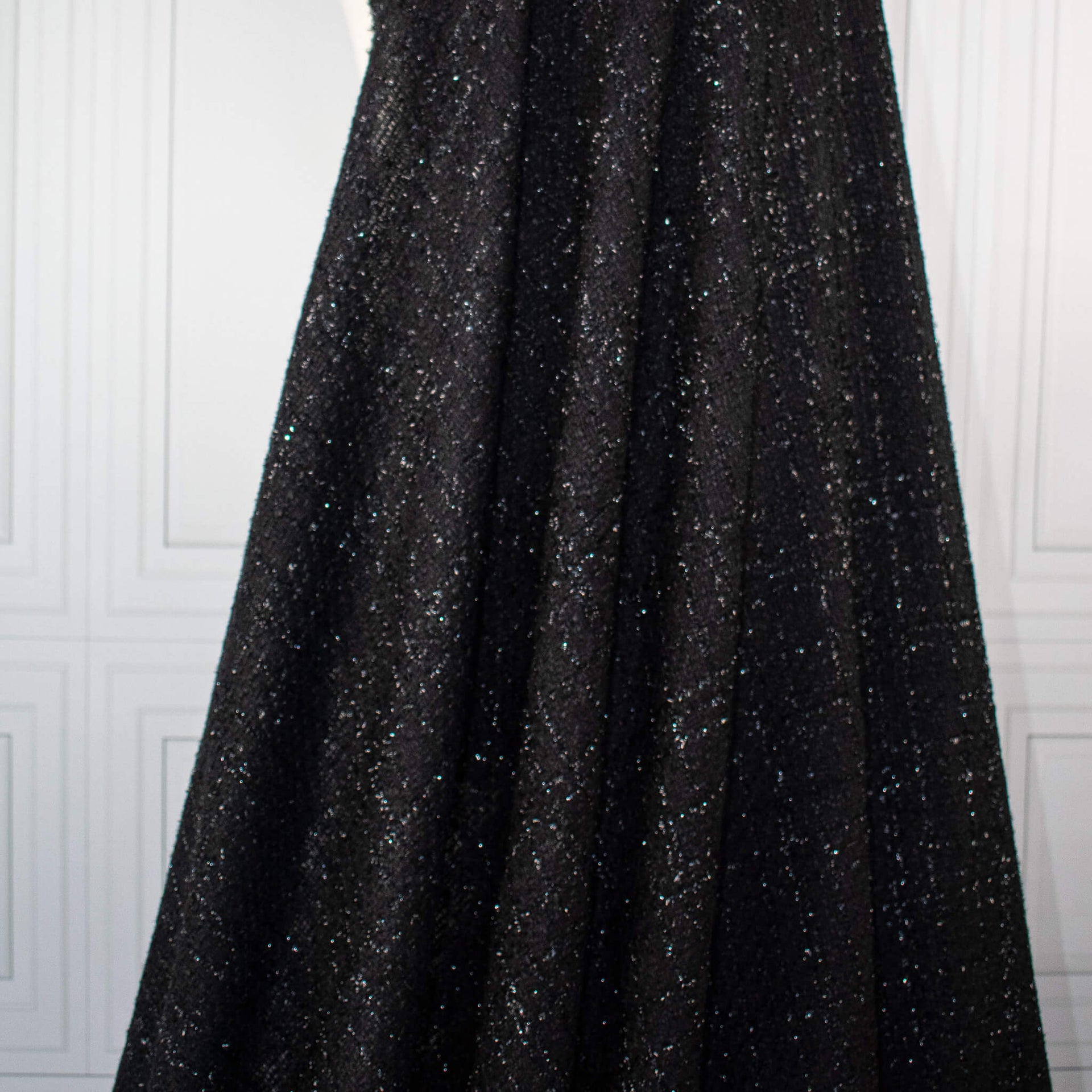 Designer Black Boucle fabric draped on dressform.