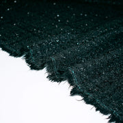 Designer Black boucle fabric close up. of selvedge.