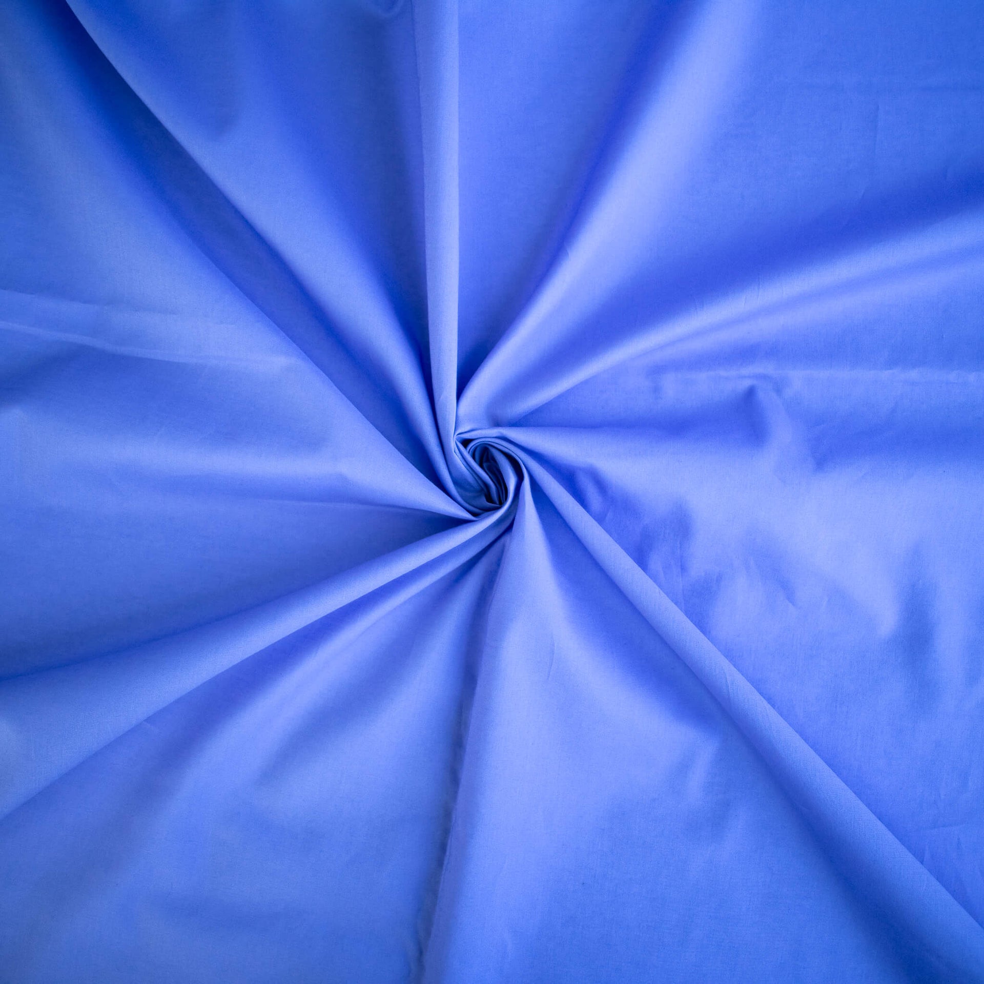 Close-up of blue cotton lawn designer fabric.