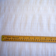 White dimity designer fabric with a ruler for pattern scale