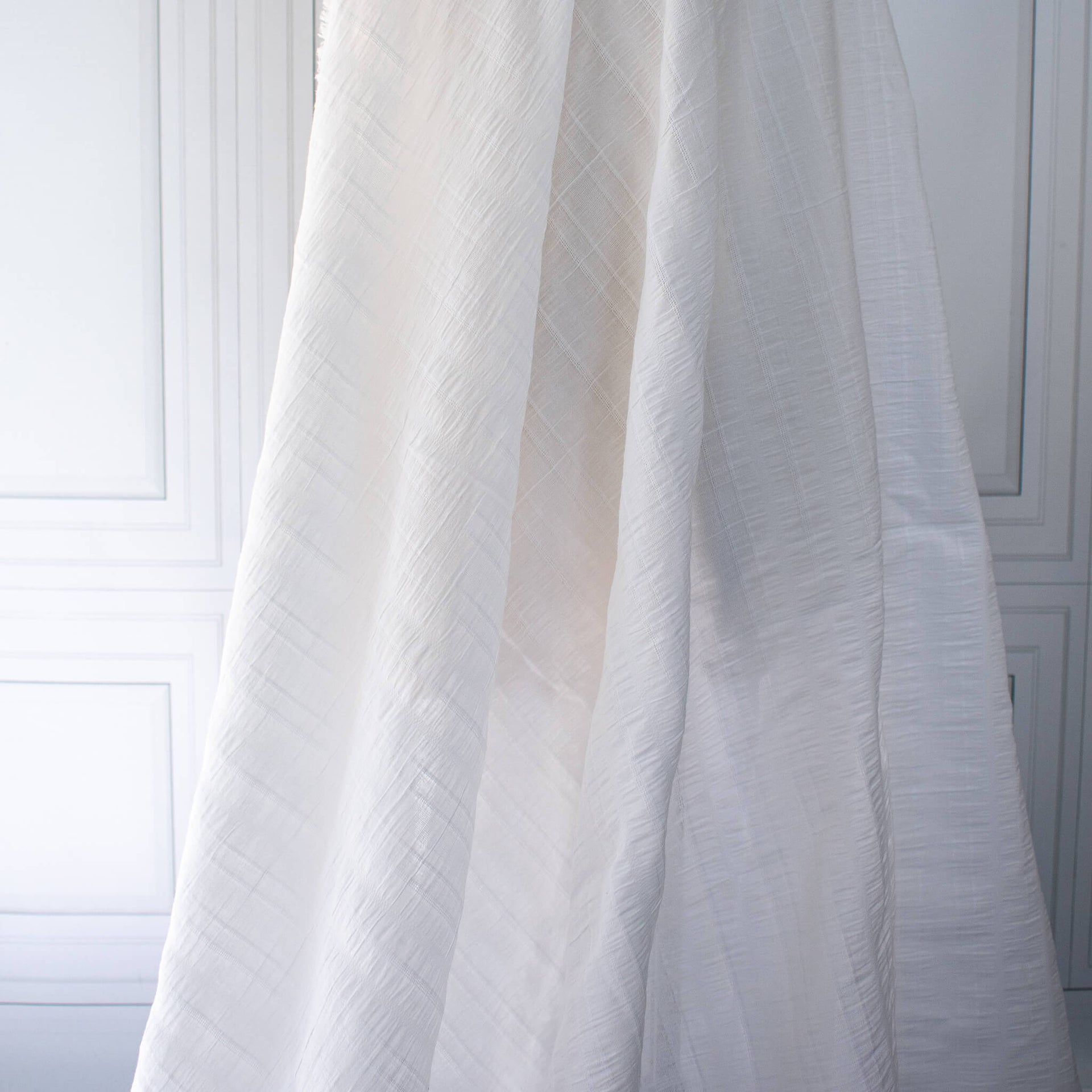 Designer white dimity  fabric draped on dressform