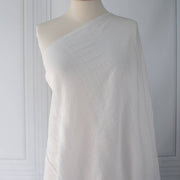 Close-up of white dimity designer fabric draped on dressform