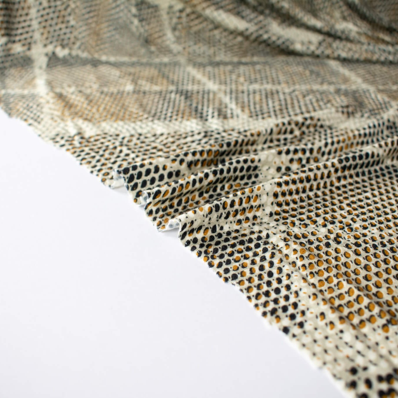 Italian Geometric Animal Print knit fabric by the yard directly from Ratti, the renowned mills know for its excellence in textiles. The elegant shades of browns and tans make it perfect for a sophisticated knit top or as a versatile choice for the latest designer wrap dress. Image of selvedge.