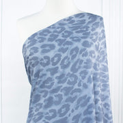 French Animal Print Fine Knit Crepe fabric by the yard in shades of blue. Liven up your next project with a gorgeous animal print that pairs well with navy, gray, purple and white. This translucent fine crepe has a lightly textured hand, a bit of stretch, and a lovely graceful drape. Close up image of fabric on dressform.