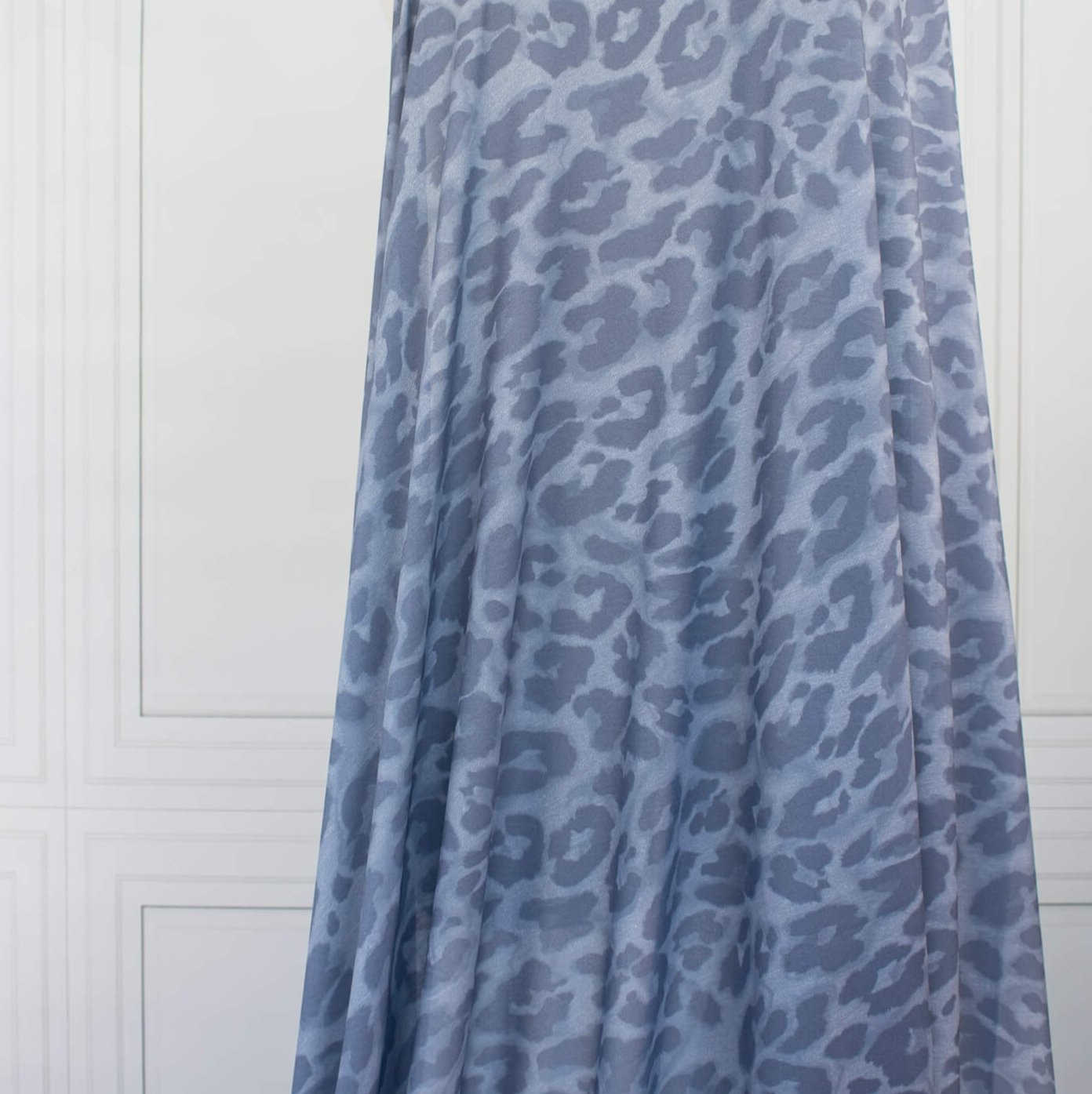 French Animal Print Fine Knit Crepe fabric by the yard in shades of blue. Liven up your next project with a gorgeous animal print that pairs well with navy, gray, purple and white. This translucent fine crepe has a lightly textured hand, a bit of stretch, and a lovely graceful drape.  Image of fabric drape.