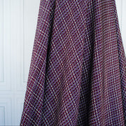 Image of fabric drape. Italian Viscose Satin Modern Geometric Print designer deadstock fabric by the yard. From the Italian mills, enjoy a sophisticated geometric print of small squares in shades of purple highlighted by an ivory background. A cool smooth hand and satiny sheen is perfect for creating a top or dress that can take you from day to evening.