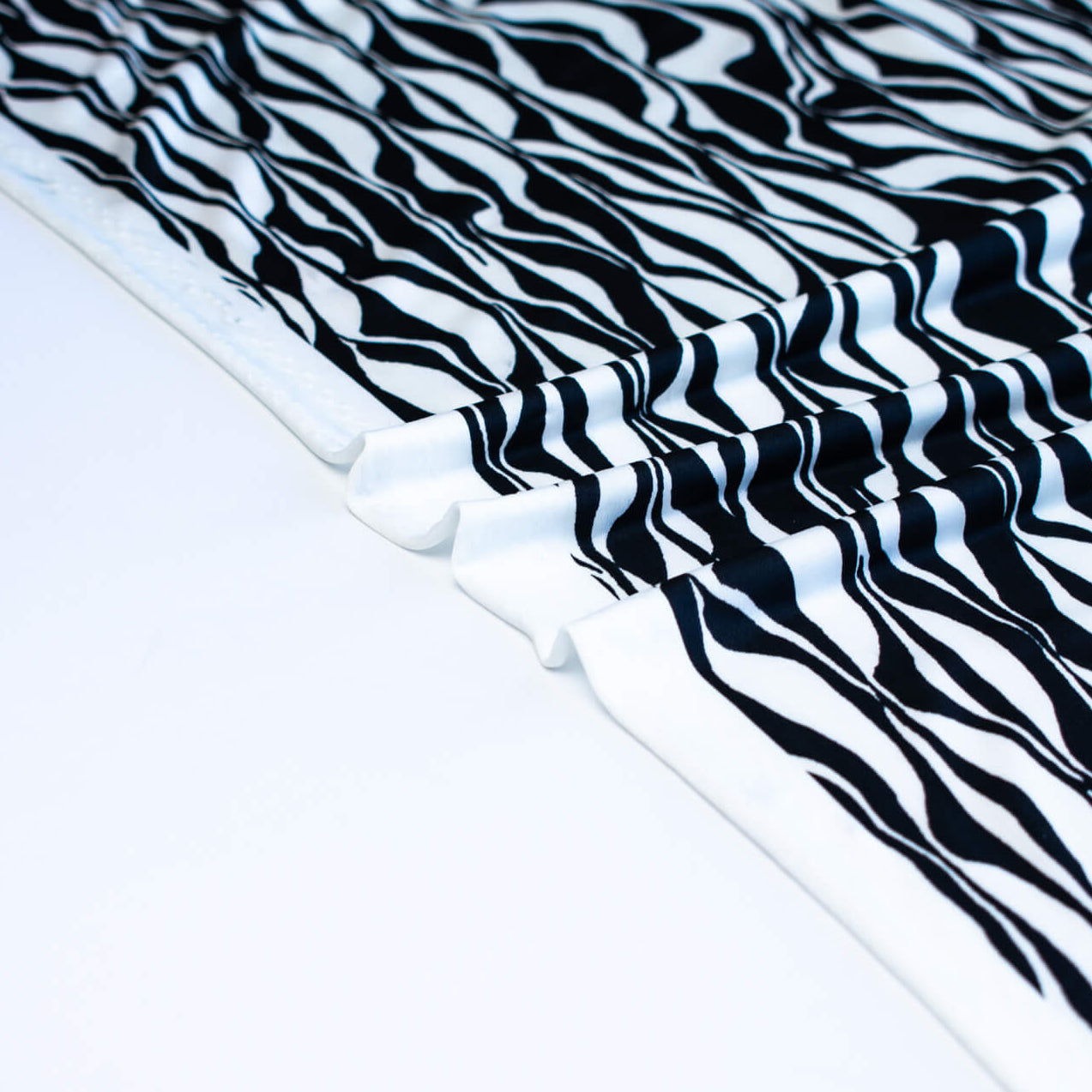 Close up selvedge  of Black and Ivory Italian ITY jersey knit fabric by the yard 