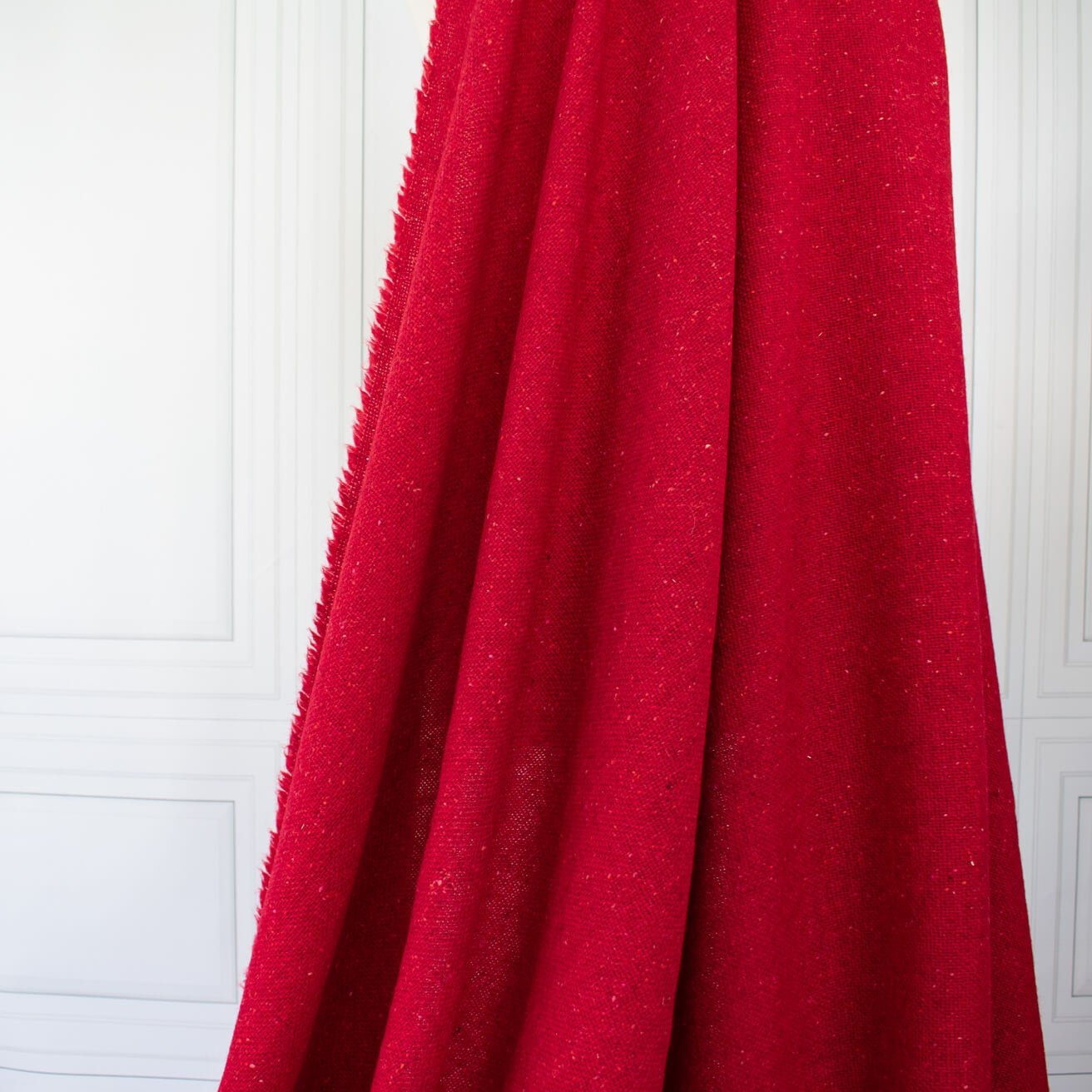 Italian Couture Red Melange YS1 Designer Boucle Virgin Wool fabric by the yard. Discreet luxury at its finest, this beautiful woolen boucle from an exclusive design house is the epitome of French elegance. Image of fabric drape.