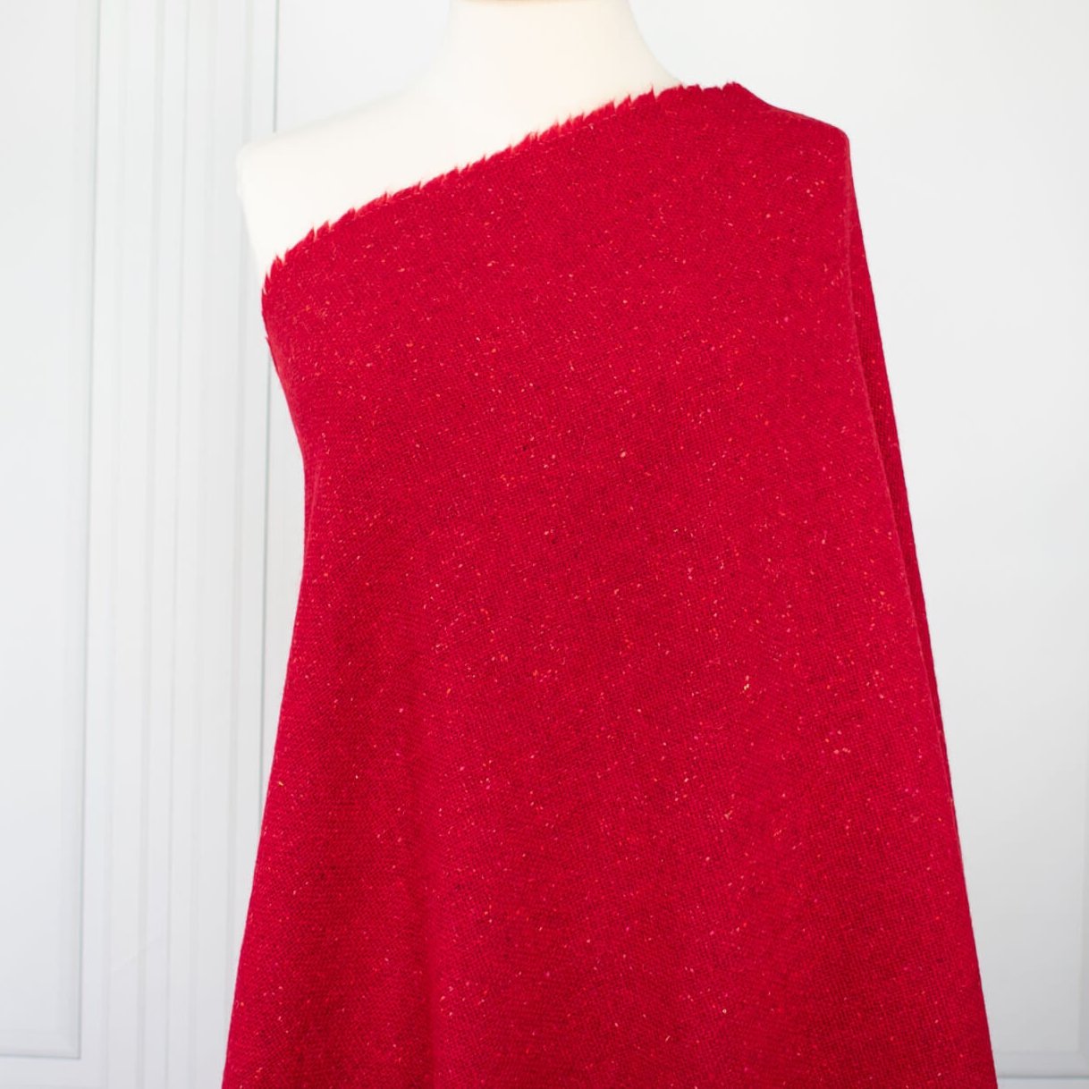 Italian Couture Red Melange YS1 Designer Boucle Virgin Wool fabric by the yard. Discreet luxury at its finest, this beautiful woolen boucle from an exclusive design house is the epitome of French elegance. Image of fabric on dressform.