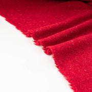 Italian Couture Red Melange YS1 Designer Boucle Virgin Wool fabric by the yard. Discreet luxury at its finest, this beautiful woolen boucle from an exclusive design house is the epitome of French elegance. Image of selvedge.