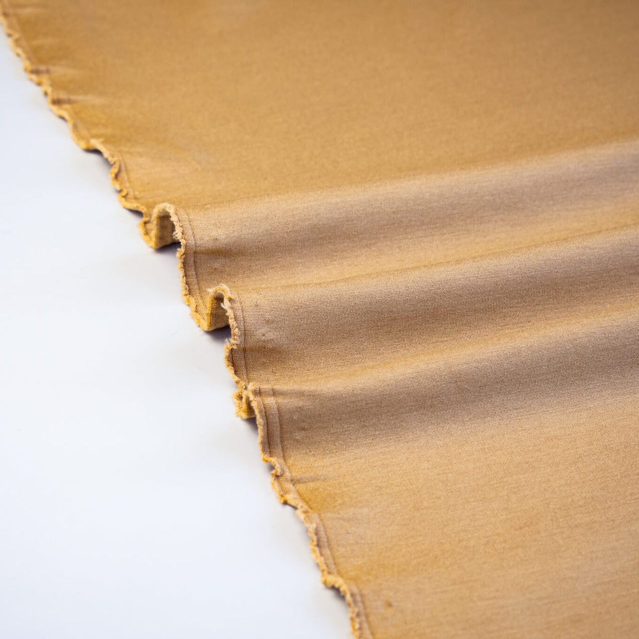 Close-up of High End British Designer Ponte De Milano  fabric selvedge in a classic tan color