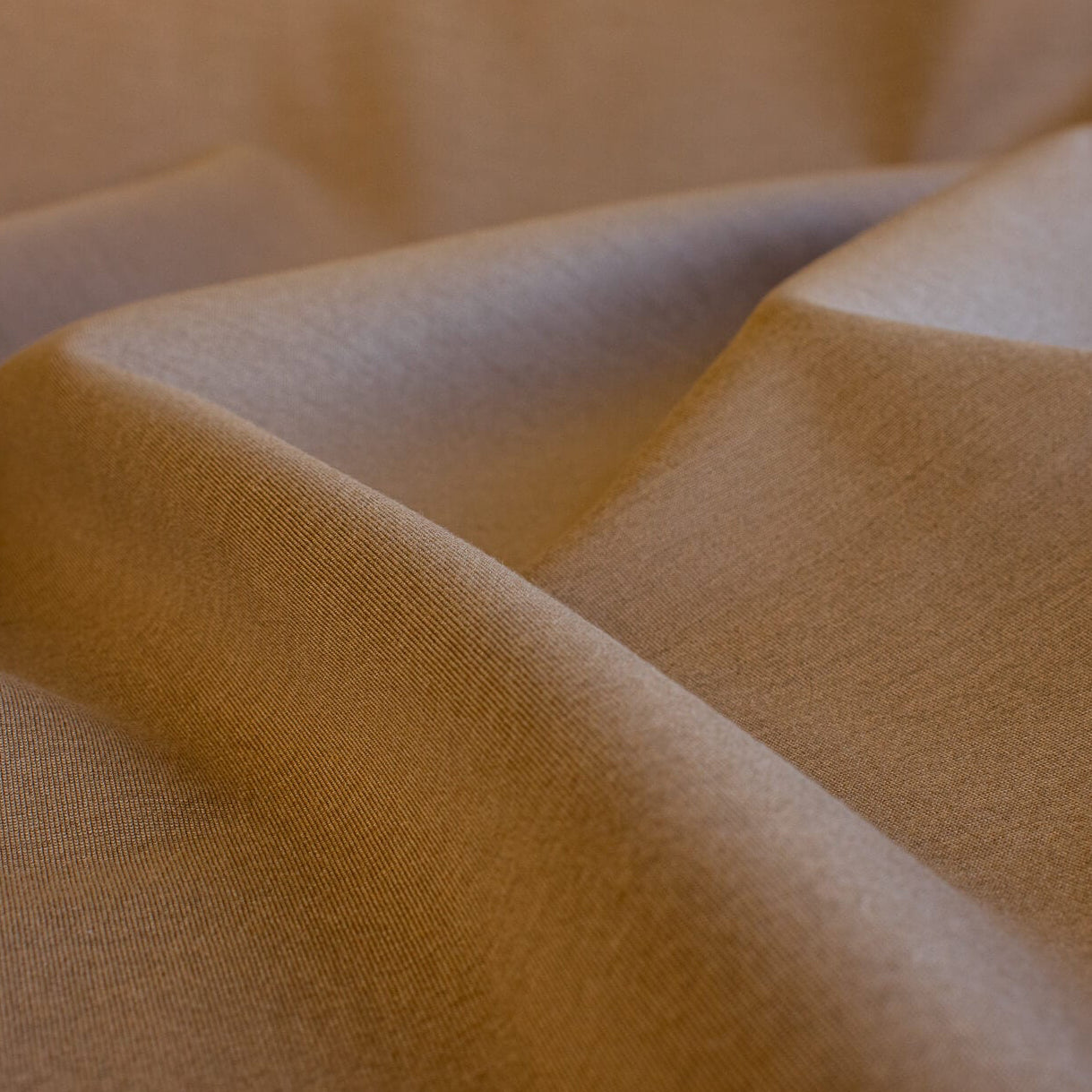 Close-up of High End British Designer Ponte De Milano  fabric in a classic tan color