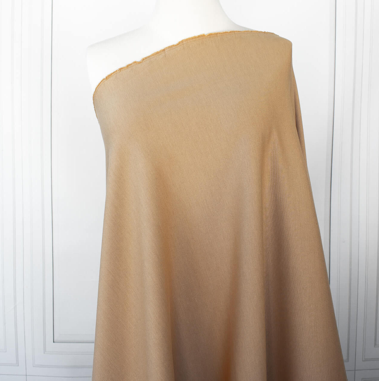 Image on dressform of High End British Designer Ponte De Milano  fabric in a classic tan color