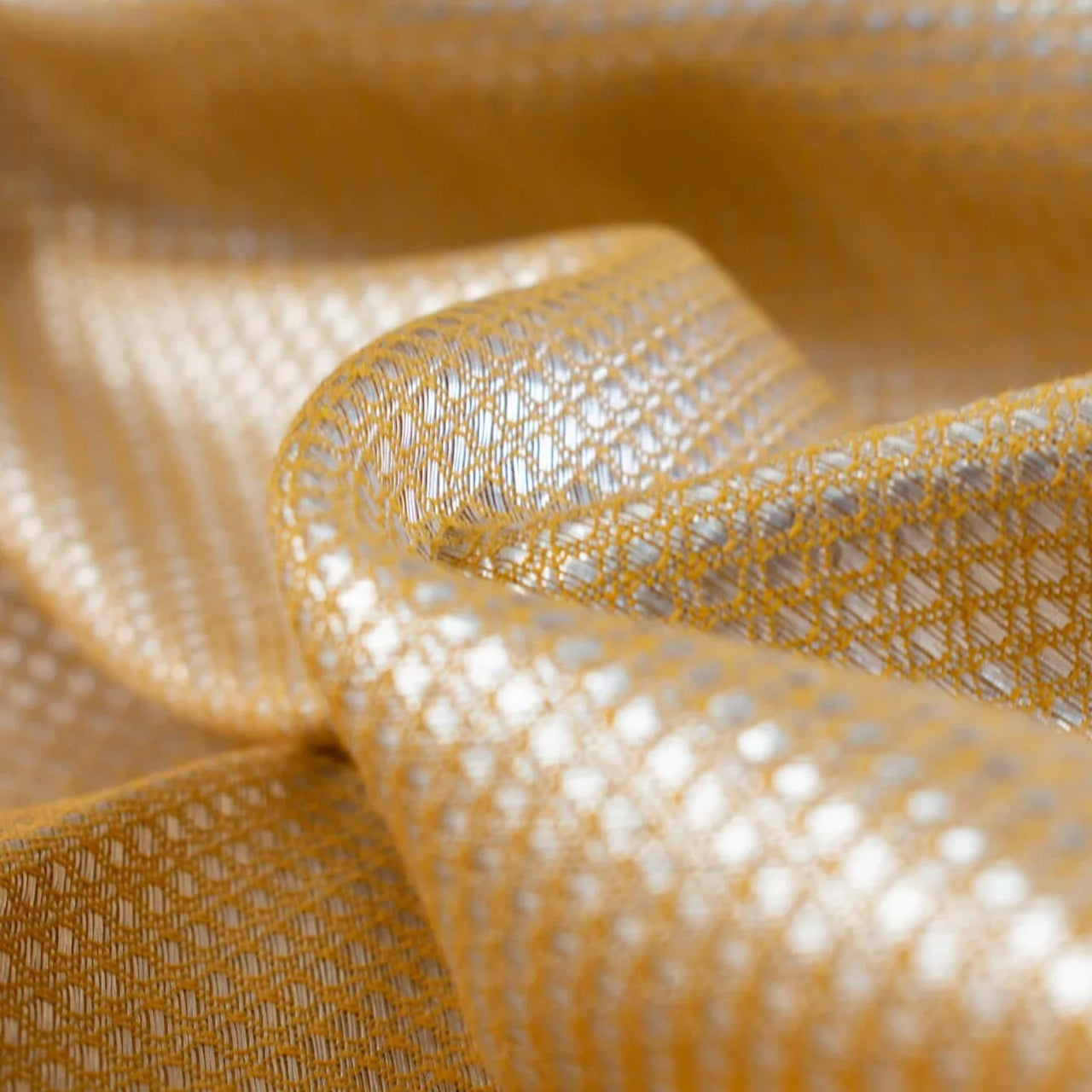 Close up image of Beverly Hills with this vintage designer deadstock. A gold jacquard with a timeless silver metallic geometric design 