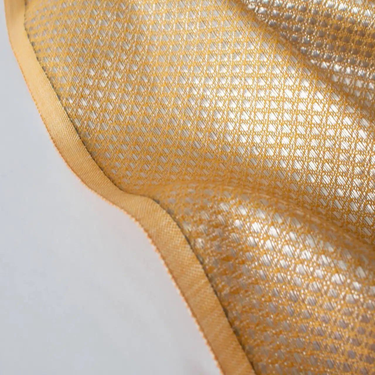 Close-up image of selvedge - Beverly Hills with this vintage designer deadstock. A gold jacquard with a timeless silver metallic geometric design 