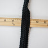 This classic Black Wool Blend Fold-Over Knitted Trim is a timeless choice for couture designs, adding a sophisticated touch of designer embellishment. With its luxurious knitted texture and fold-over shape, this trim will make any look iconic.  Choose your look... this trim can be used flat, or fold-over, which is especially nice for double-sided fabrics! Photo of trim on ruler to demonstrate flat width.