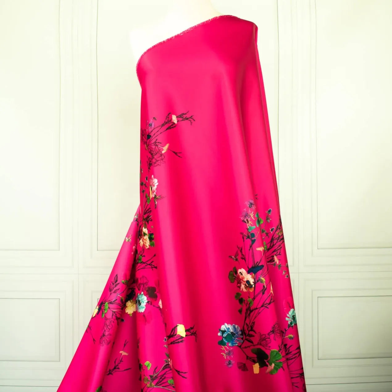 Image of Couture dark pink duchesse satin fabric draped on dress form.